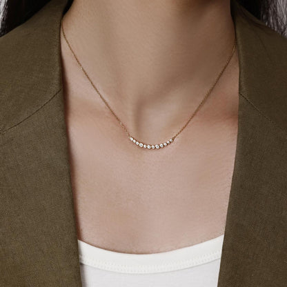 Model wearing a curve of bezel-set Graduated round diamonds Necklace 1.34" Diamond Segment (34mm)