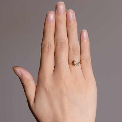 Model wearing a diamond engagement ring on finger, minimalist and radiant look
