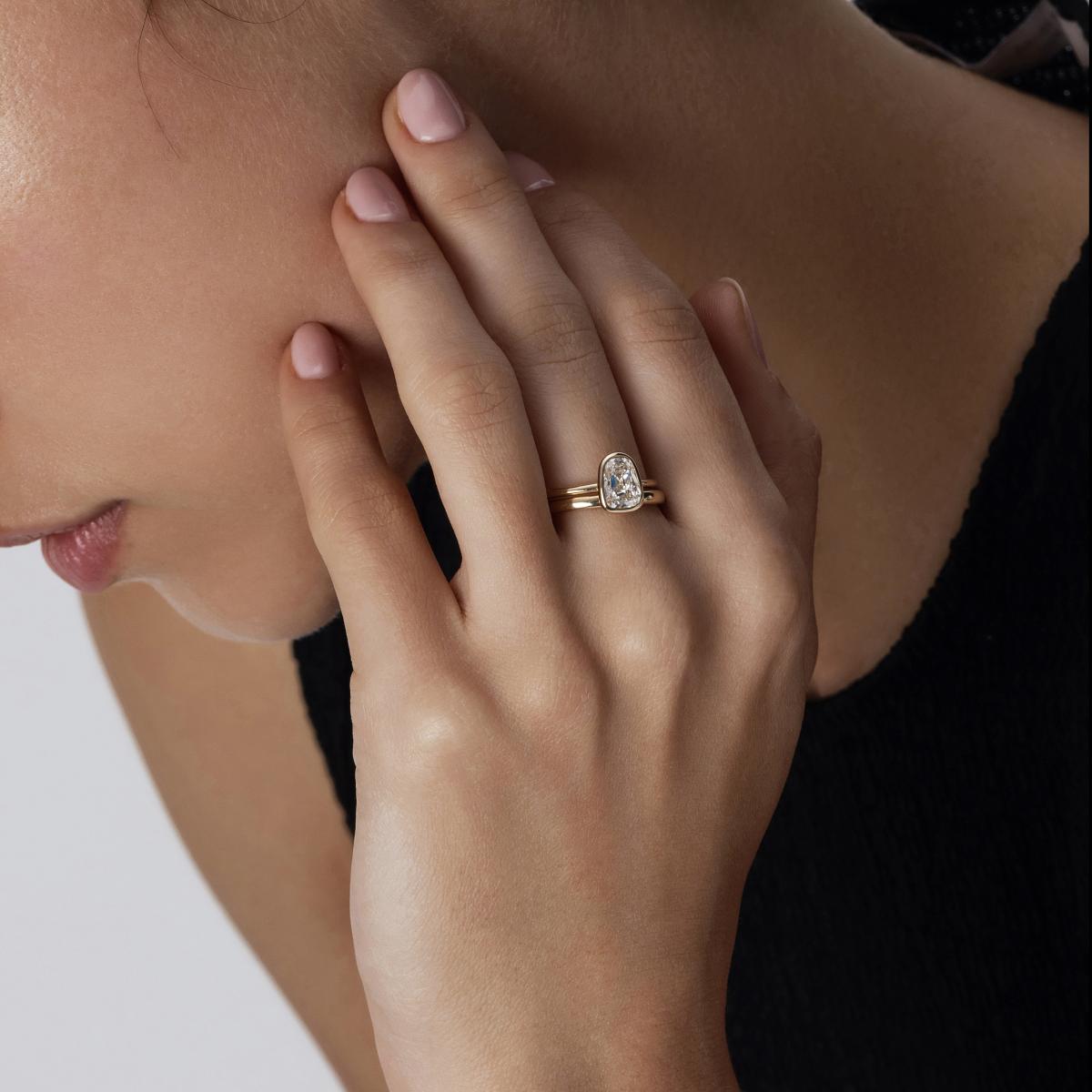 Side hand view of model wearing 1ct Emma Old European cut diamond ring in bezel setting