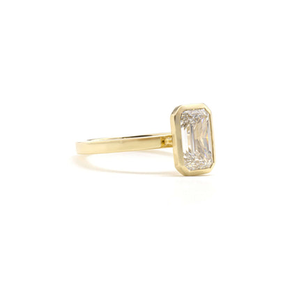 Side profile of Aurora Ring showcasing emerald-cut diamond in bezel setting