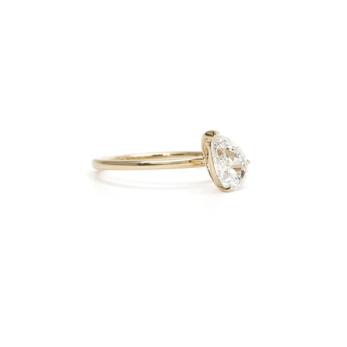 Side view of the Violet diamond ring showing tapered pear cut and slim band