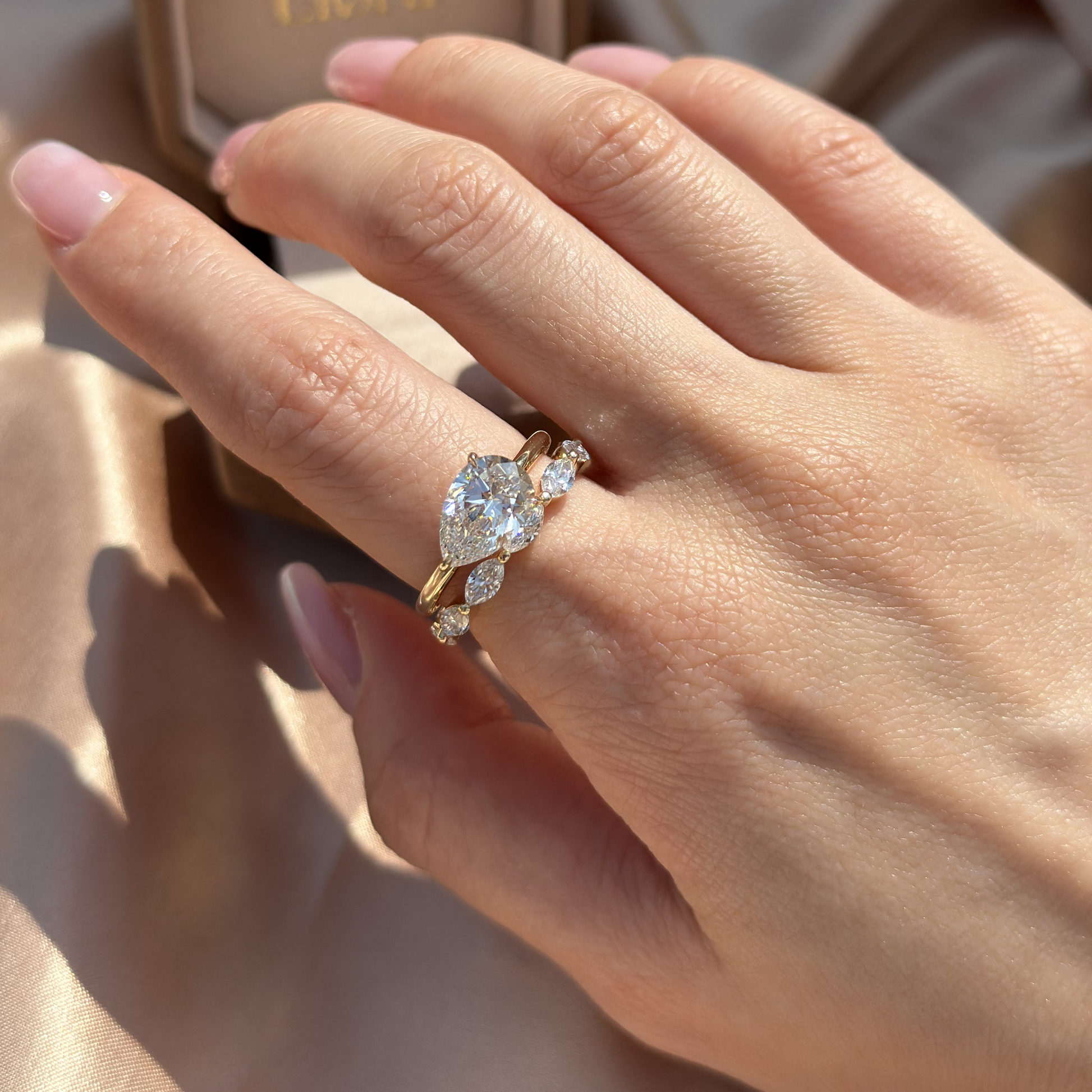 Stacked ring look featuring a solitaire diamond ring and a delicate pavé band in yellow gold