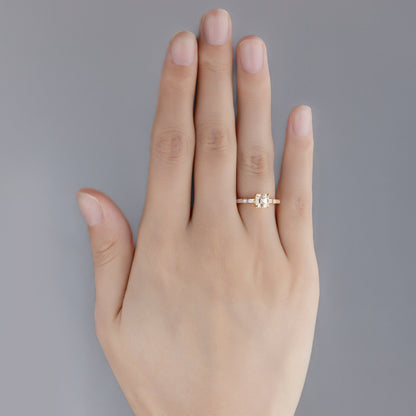 Top view of hand wearing Asscher cut lab-grown diamond pavé ring with Side stones in 14K gold