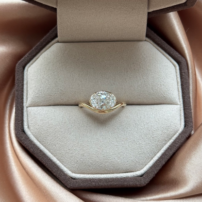 Wave-Oval Cut Lab Grown Diamond Engagement Ring on a plush display cushion.