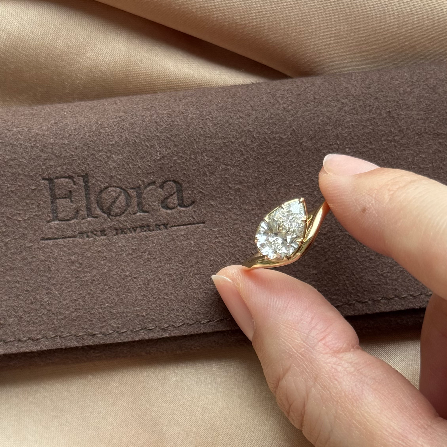Wave-Pear Cut Yellow Gold Lab Grown Diamond Engagement Ring displayed in Elora fine jewelry packaging.